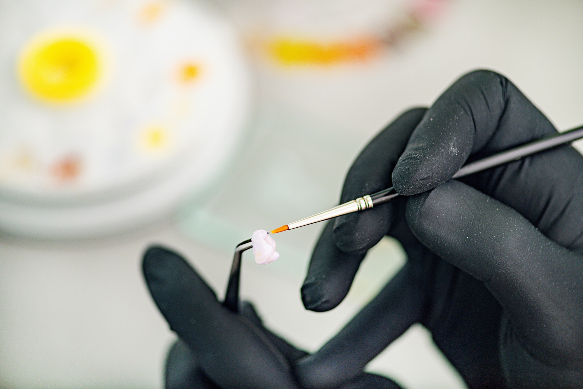 Dental Technician Preparing Ceramic Tooth Crown. Prosthetic Dentistry.